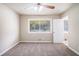 Spacious bedroom featuring soft carpet, ceiling fan, and a bright window for natural light at 474 Waterford Nw Rd, Atlanta, GA 30318