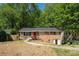 Charming brick home with mature trees and inviting front door at 474 Waterford Nw Rd, Atlanta, GA 30318