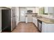 Well-lit kitchen with stainless steel appliances, white cabinets, and granite countertops at 474 Waterford Nw Rd, Atlanta, GA 30318