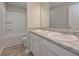 Bathroom with double sinks, white cabinets, and a shower-tub combo at 488 Charleston Pl, Villa Rica, GA 30180