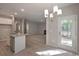 Bright dining area featuring hardwood floors, modern chandelier, and access to the outdoor deck at 488 Charleston Pl, Villa Rica, GA 30180