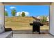 View from covered patio featuring a grill, outdoor seating, and a beautiful view of the landscaped backyard at 5520 Allegre Pl, Cumming, GA 30028