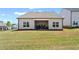 Large backyard with well-maintained lawn, patio, and view of the rear of the house with several large windows at 5520 Allegre Pl, Cumming, GA 30028