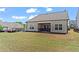 Expansive backyard showing the covered patio, lush lawn, and the home's exterior at 5520 Allegre Pl, Cumming, GA 30028