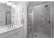 Modern bathroom boasts an elegant shower with marble-like tile and glass door at 5520 Allegre Pl, Cumming, GA 30028