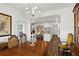 Charming dining room with chandelier leads into an open concept kitchen and living room space at 5520 Allegre Pl, Cumming, GA 30028
