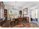Charming dining room with elegant chandelier, built in cabinets, and view of the outdoors at 5520 Allegre Pl, Cumming, GA 30028