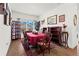 Cozy dining room with a large window, hardwood floors, and comfortable seating for Gathering meals at 5520 Allegre Pl, Cumming, GA 30028