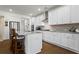 Modern kitchen features granite countertops, stainless appliances, and large island with seating at 5520 Allegre Pl, Cumming, GA 30028