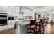 Modern kitchen features granite countertops, stainless appliances, and a large island with seating at 5520 Allegre Pl, Cumming, GA 30028