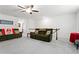 Upstairs living room with comfortable sofas, ceiling fan, and neutral carpet at 5520 Allegre Pl, Cumming, GA 30028