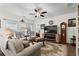 Inviting living room boasts lots of natural light, a ceiling fan, and a cozy fireplace at 5520 Allegre Pl, Cumming, GA 30028