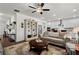 Open-concept living room with hardwood floors and seamless access to the kitchen area at 5520 Allegre Pl, Cumming, GA 30028