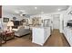 Open concept kitchen and living room boasts granite countertops, stainless appliances, and ceiling fan at 5520 Allegre Pl, Cumming, GA 30028