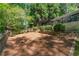 Spacious backyard with stone retaining walls and a mulched area, perfect for gardening or outdoor activities at 2620 Margaret Mitchell Dr, Atlanta, GA 30327