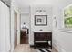 Neutral bathroom with dark wood vanity, stone floors, decorative mirror, and a view to the bedroom at 2620 Margaret Mitchell Dr, Atlanta, GA 30327