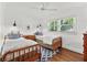 Bright bedroom with two twin beds, hardwood floors, ceiling fan, and natural light at 2620 Margaret Mitchell Dr, Atlanta, GA 30327