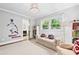 Neutral bedroom with sofa, books, windows, access to a bathroom, and Braves accents at 2620 Margaret Mitchell Dr, Atlanta, GA 30327