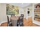 Dining area with hardwood floors, round table, woven chairs, and bright artwork at 2620 Margaret Mitchell Dr, Atlanta, GA 30327