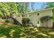 Back exterior view of the home featuring a small staircase, green lawn and minimal landscaping at 2620 Margaret Mitchell Dr, Atlanta, GA 30327