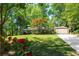 Charming single-story home with a well-manicured lawn and mature trees providing ample shade at 2620 Margaret Mitchell Dr, Atlanta, GA 30327