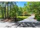 Inviting home featuring a long driveway and beautiful landscaping, providing a serene and private setting at 2620 Margaret Mitchell Dr, Atlanta, GA 30327