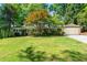 Attractive single-story home with a lush green lawn, mature trees and charming curb appeal at 2620 Margaret Mitchell Dr, Atlanta, GA 30327
