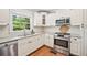 Updated kitchen with stainless steel appliances, granite countertops, and wood floors at 2620 Margaret Mitchell Dr, Atlanta, GA 30327
