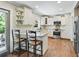 Kitchen with an island, white cabinets, granite countertops and stainless appliances at 2620 Margaret Mitchell Dr, Atlanta, GA 30327