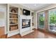 Living room with a fireplace, built-in shelves, and french doors to outdoor area at 2620 Margaret Mitchell Dr, Atlanta, GA 30327