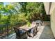 Outdoor patio with stone floors and a rustic wooden dining table, ideal for entertaining amidst lush greenery at 2620 Margaret Mitchell Dr, Atlanta, GA 30327