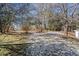 Spacious backyard with sparse vegetation and trees, offering potential for landscaping at 3595 South Nw St, Duluth, GA 30096