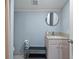 Bathroom features a stylish vanity with granite countertops and a round mirror at 3595 South Nw St, Duluth, GA 30096