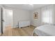 Bright bedroom featuring wood flooring, white trim, and a soothing color palette at 3595 South Nw St, Duluth, GA 30096
