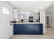 Open-concept kitchen with stylish two-tone cabinets and granite countertops at 3595 South Nw St, Duluth, GA 30096