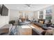 Bright living room featuring a ceiling fan, large windows, and comfortable seating area at 3595 South Nw St, Duluth, GA 30096