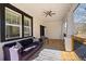 Inviting covered porch with wood flooring, comfortable seating and stylish ceiling fan at 3595 South Nw St, Duluth, GA 30096