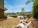 Community backyard with view of neighborhood pool and lawn chairs for relaxing at 3862 Firewood Ln # 110, Suwanee, GA 30024