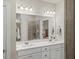 Bathroom with double vanity, white cabinetry, quartz countertops, and tile backsplash at 3862 Firewood Ln # 110, Suwanee, GA 30024