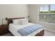Bedroom features a bed, side tables and a large window at 3862 Firewood Ln # 110, Suwanee, GA 30024