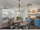 Open dining area with stylish lighting and access to the living room and bar area at 3862 Firewood Ln # 110, Suwanee, GA 30024