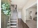 Stylish entryway showcasing hardwood floors, staircase, and seamless transition to the living spaces and bathroom at 3862 Firewood Ln # 110, Suwanee, GA 30024