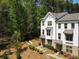 Exterior shot of townhomes with a well-manicured lawn, trees, and blue sky at 3862 Firewood Ln # 110, Suwanee, GA 30024