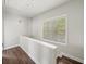 Hallway with hardwood floors and window with natural light at 3862 Firewood Ln # 110, Suwanee, GA 30024
