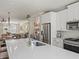 Modern kitchen boasts stainless steel appliances and a large island with stone countertops at 3862 Firewood Ln # 110, Suwanee, GA 30024