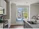 Bright kitchen with white cabinets and a cozy window seat at 3862 Firewood Ln # 110, Suwanee, GA 30024