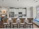 Kitchen with large center island, barstool seating, and white cabinetry at 3862 Firewood Ln # 110, Suwanee, GA 30024