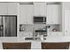 Kitchen with stainless steel appliances, white cabinetry, and an island at 3862 Firewood Ln # 110, Suwanee, GA 30024
