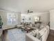 Spacious living room with a comfortable couch and hardwood flooring at 3862 Firewood Ln # 110, Suwanee, GA 30024