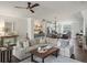Open-concept living room features a large sectional sofa, ceiling fan, and elegant decor at 3862 Firewood Ln # 110, Suwanee, GA 30024